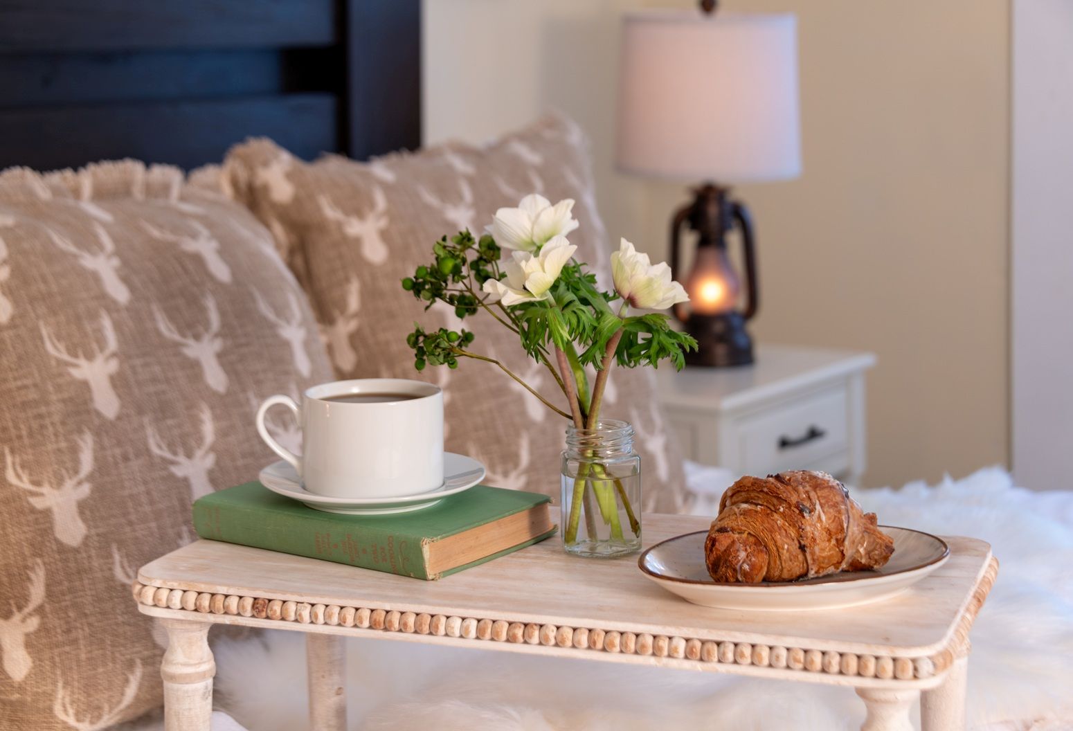 Coffee and a croissant on a serving tray in a guest room at Tucker Hill Lodge in Vermont